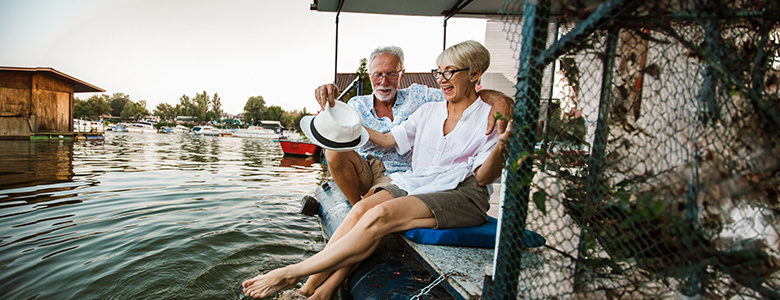 An older couple enjoys sitting by the water