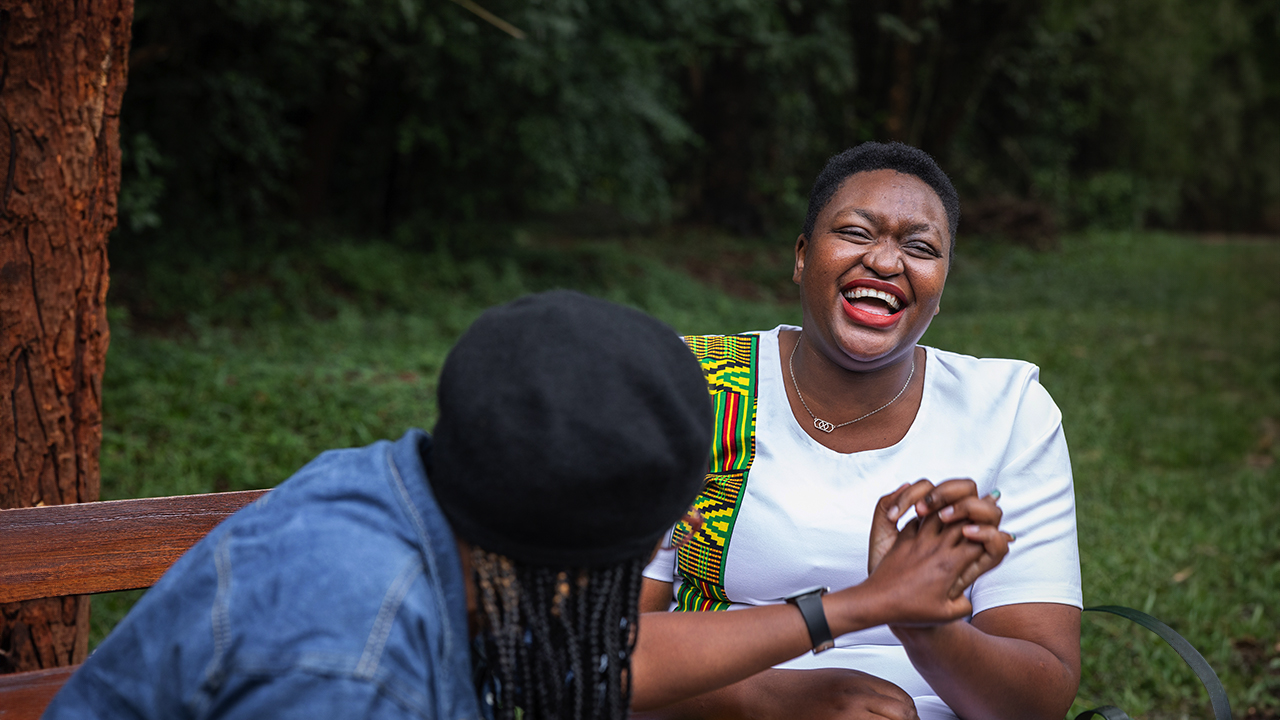 A woman laughs with a friend